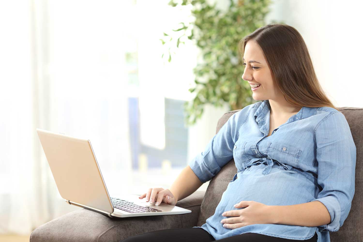 Woman at Laptop searching for a pregnancy center website