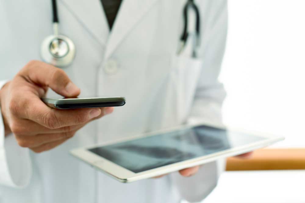 Doctor with phone on HIPAA Compliant Page