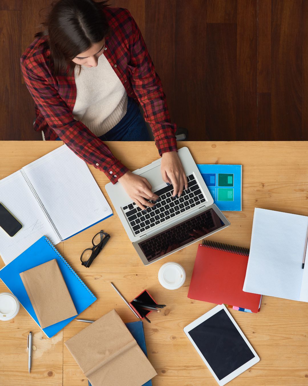 flat lay of a woman working on adapting to the world of ai on her website.